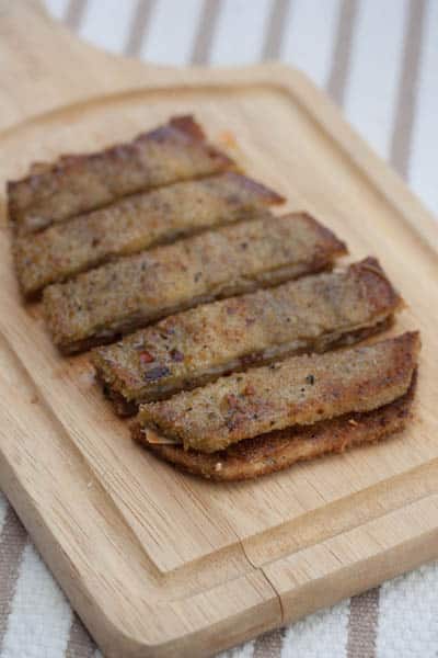 Fried eggplant and manchego sandwich sliced into strips.