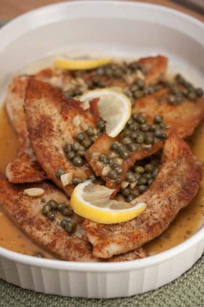 Platter of turkey scallopini with lemon and capers.