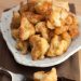 A plate of fried cauliflower with a fork.