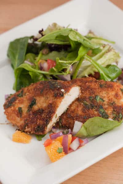 A plate of chicken cutlets with salad.