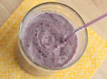 Overhead view of a blueberry banana smoothie.
