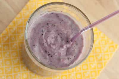 Overhead view of a blueberry banana smoothie.