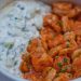 Close-up of spicy Thai shrimp with mint raita.