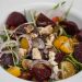 Salad topped with beets, tomatoes, blue cheese, and balsamic.