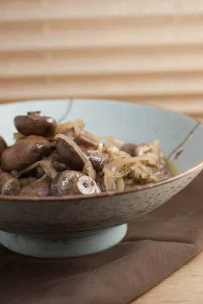A bowl of marinated mushrooms and onions.