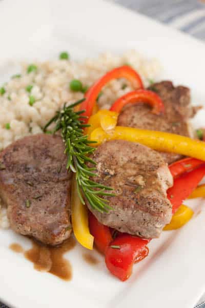 Pork tenderloin slices wtih bell peppers and rosemary.