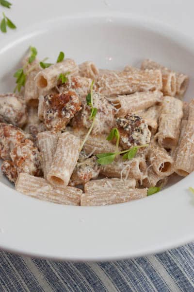 A bowl of rigatoni with sausage.