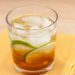 Cocktail in a glass with lime wheels.