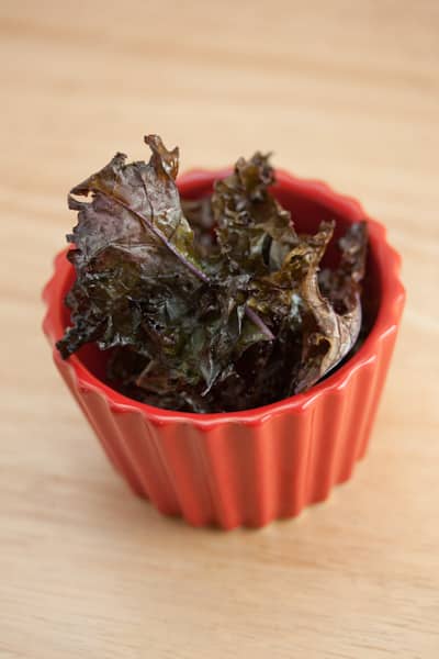 Kale chips in a red ramekin.