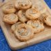 Swirled cheese crisps on a cutting board.