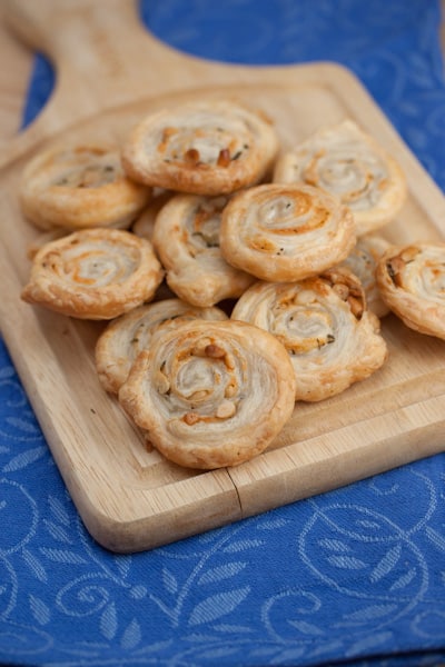 Swirled cheese crisps on a cutting board.