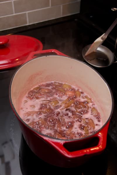 Jam simmering in a Dutch oven on the stovetop.