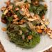 Plate of swiss chard with raisins and almonds.