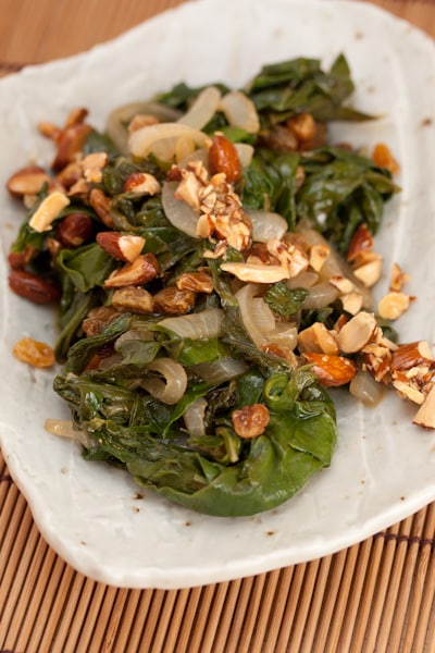 Plate of swiss chard with raisins and almonds.