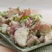 Potato salad with fresh herbs on a plate.