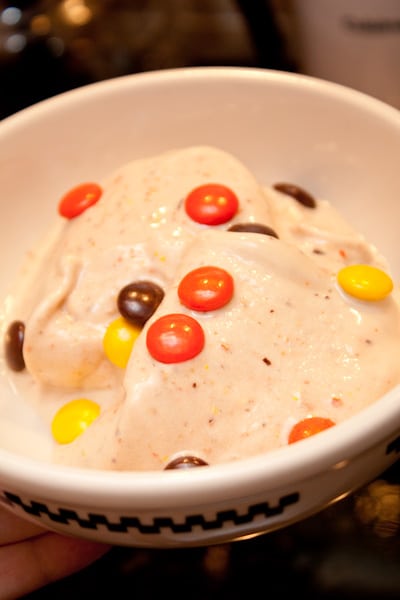 Bowl of banana ice cream with candy on top.