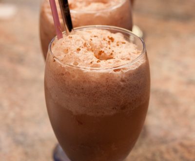 Mocha floats in glasses with spoons and straws.