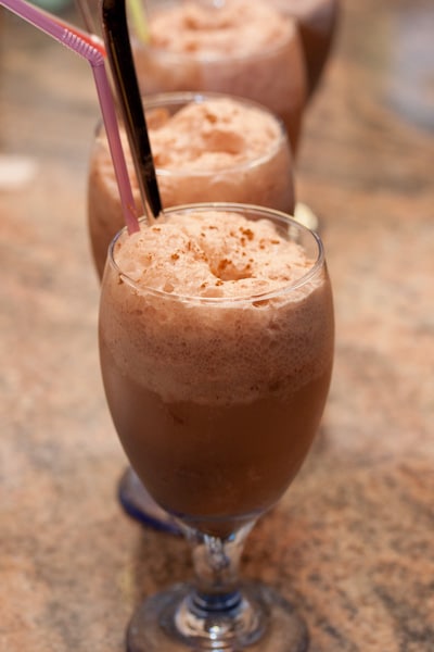 Mocha floats in glasses with spoons and straws.