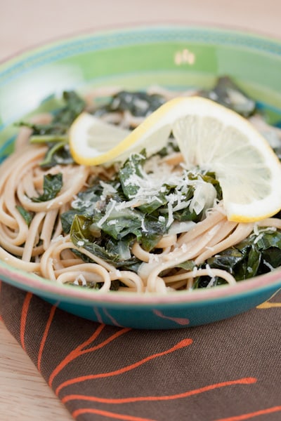 Spaghetti with braised kale and lemon in a bowl.