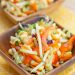 Small dishes of cabbage and corn slaw.