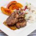 Pork tenderloin medallions with grilled peaches and rice.
