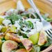 A bowl of salad topped with figs and goat cheese.