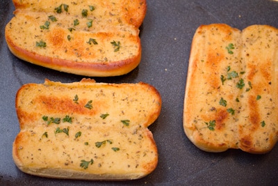 Garlic bread on a baking sheet.