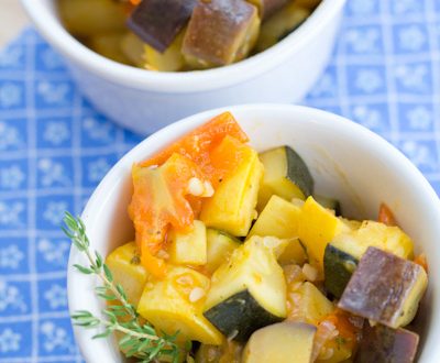 Two bowls of sautéed veggies with lemon and thyme.