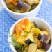Two bowls of sautéed veggies with lemon and thyme.