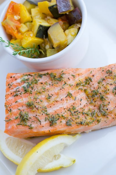 Salmon with sautéed veggie and lemon.