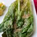 A close-up of grilled romaine with vinaigrette.