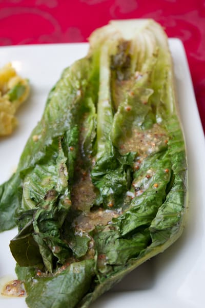 A close-up of grilled romaine with vinaigrette.