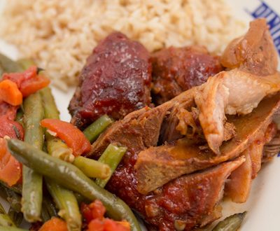 Plate with ribs, green beans, and rice.