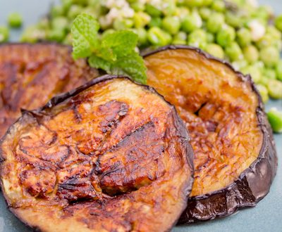 Caramelized eggplant slices with peas and fresh mint.