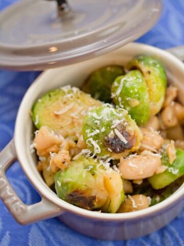 Brussels sprouts with white beans and Pecorino in a small bowl.