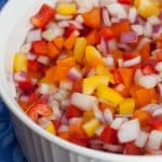 Bowl of colorful chopped bell peppers and onions.