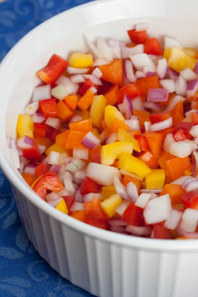 Bowl of colorful chopped bell peppers and onions