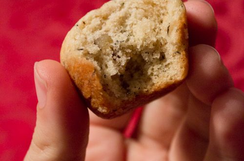 Mini banana bread muffin with a bite taken out.