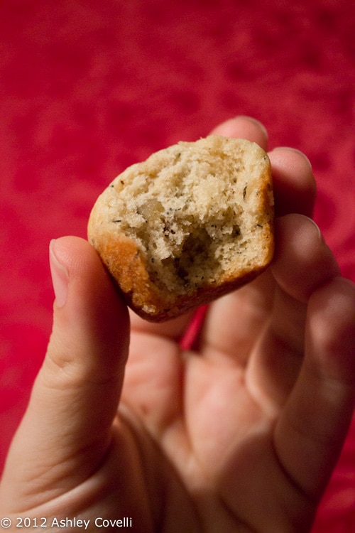 Mini banana bread muffin with a bite taken out.