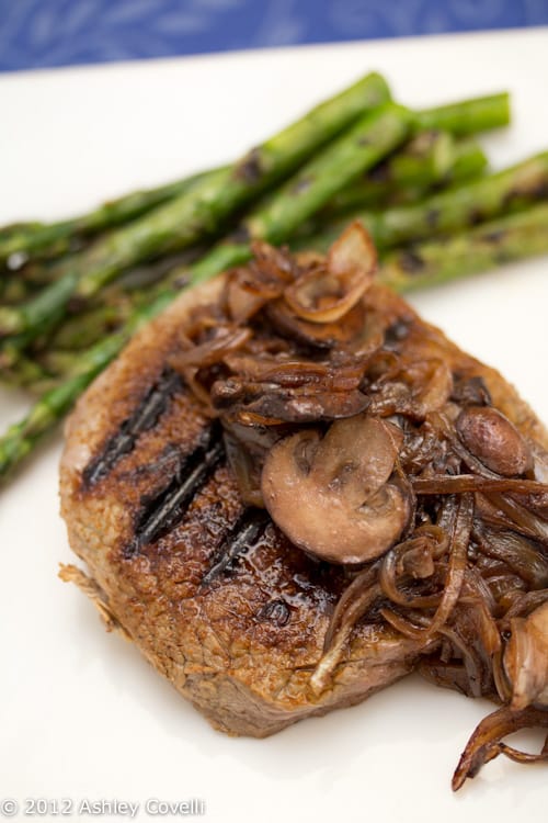 Grilled sirloin topped with mushrooms and onions with asparagus.