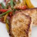 A plate of pork chops with mixed vegetables.