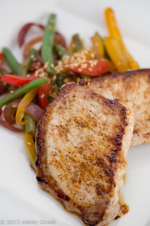 A plate of pork chops with mixed vegetables.