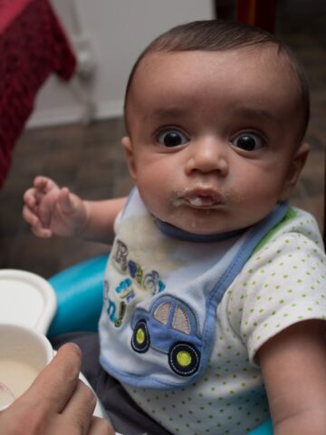 A baby sitting in a high chair.