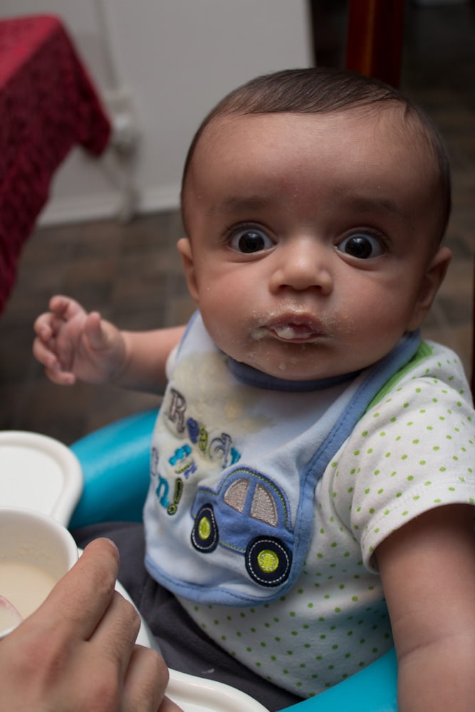 A baby sitting in a high chair.