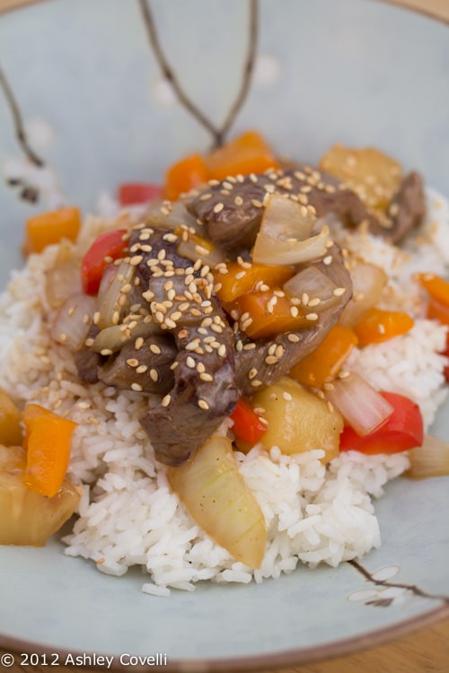 A plate of beef stir-fry over rice.
