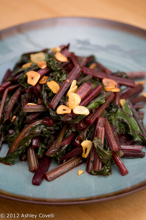 Spicy Sautéed Beet Greens with Garlic Chips: Don't toss out those beet greens! This simple side dish recipe only requires 4 ingredients and delivers lots of flavor.