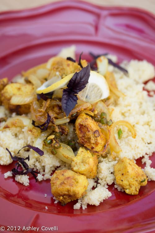 Chicken served over couscous with lemon and purple basil.