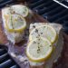 Swordfish topped with lemon and thyme being grilled on a cedar plank.