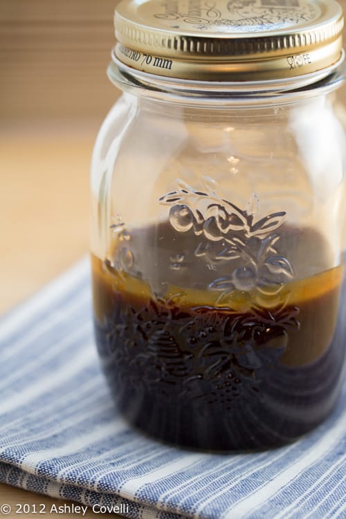 Spicy mustard BBQ sauce in a glass jar.