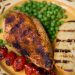 Grilled chicken with tomatoes and peas.